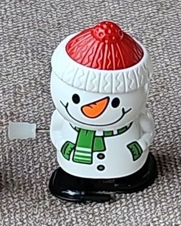 A wind up toy that looks like a snowman.