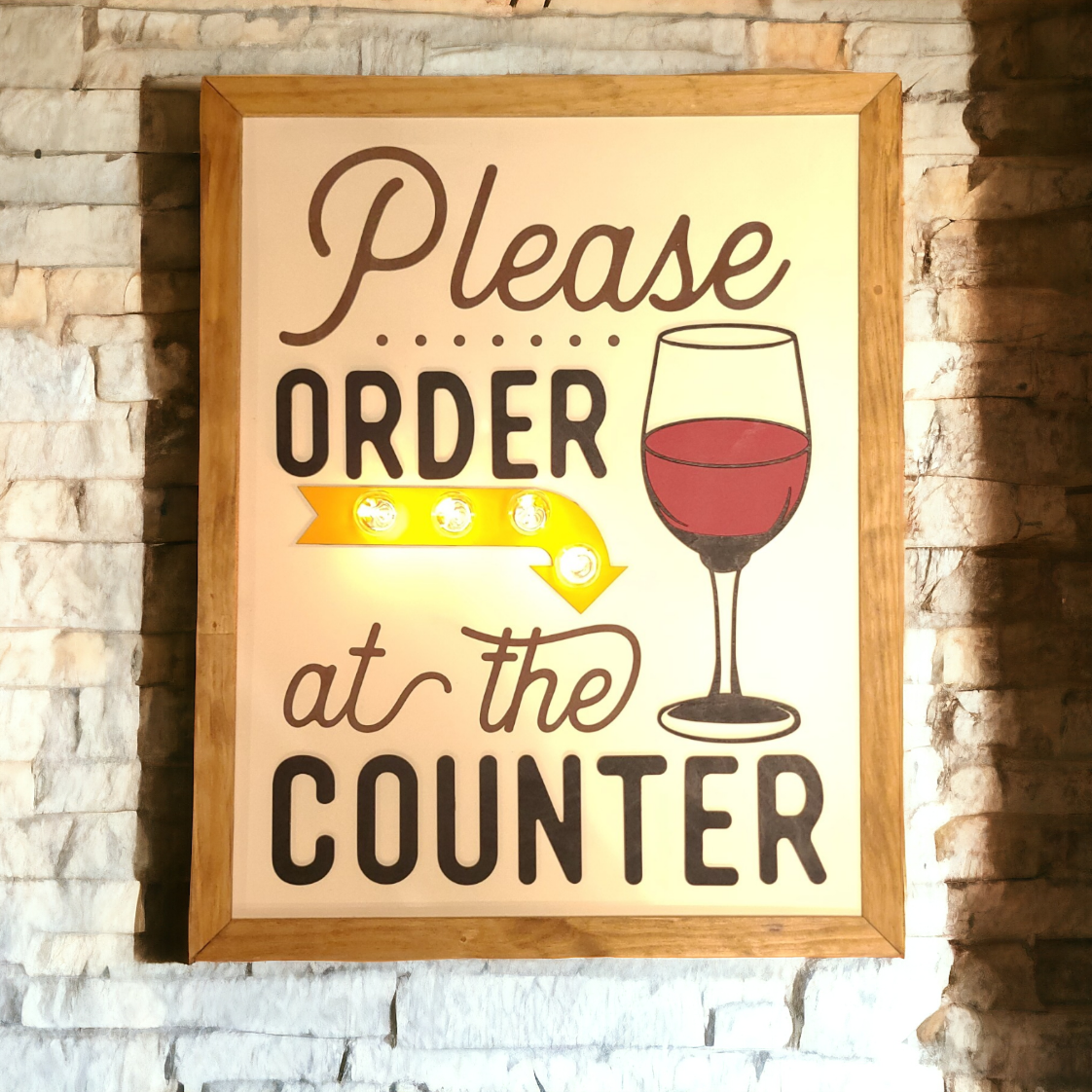 Sign that says Please order at counter that incorporates light bulbs