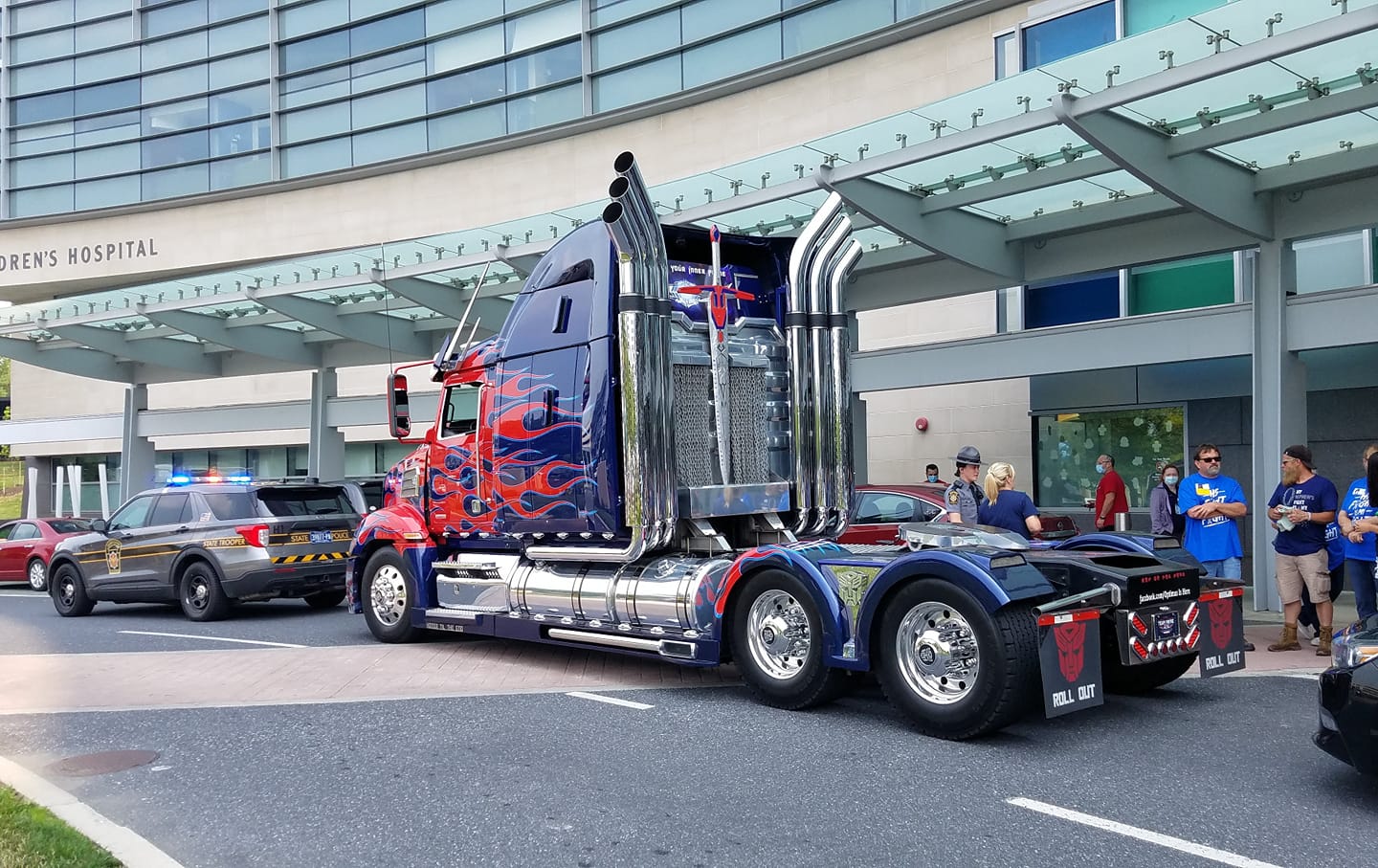 Optimus Prime escorts a young boy from the hospital back home