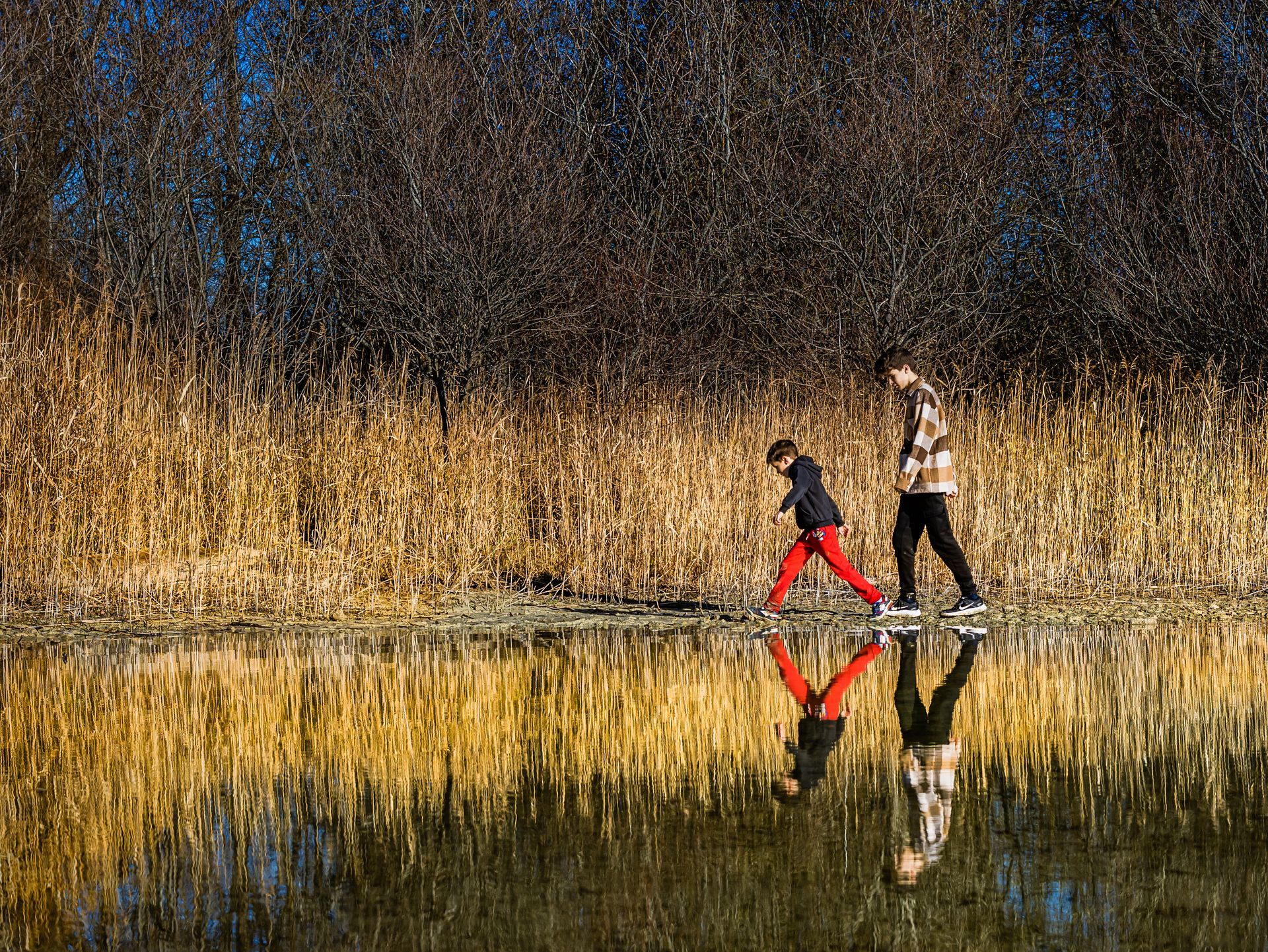 spiegelbild 2 kinder gehen am chiemsee