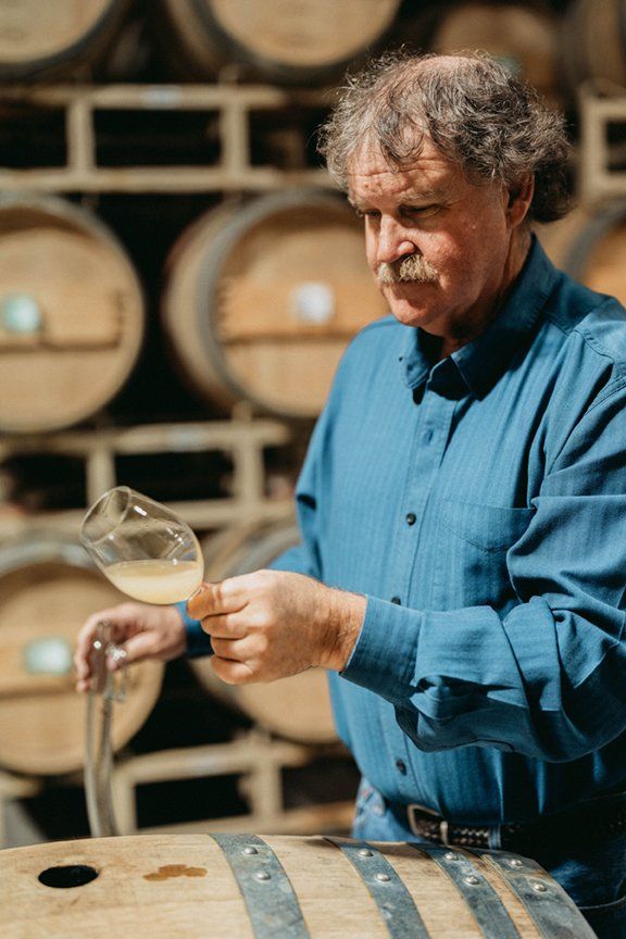 Winemaker John Gibson testing wine
