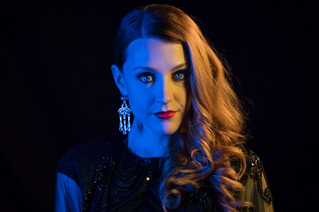 A creative colored amber and blue portrait of a woman in against a black background