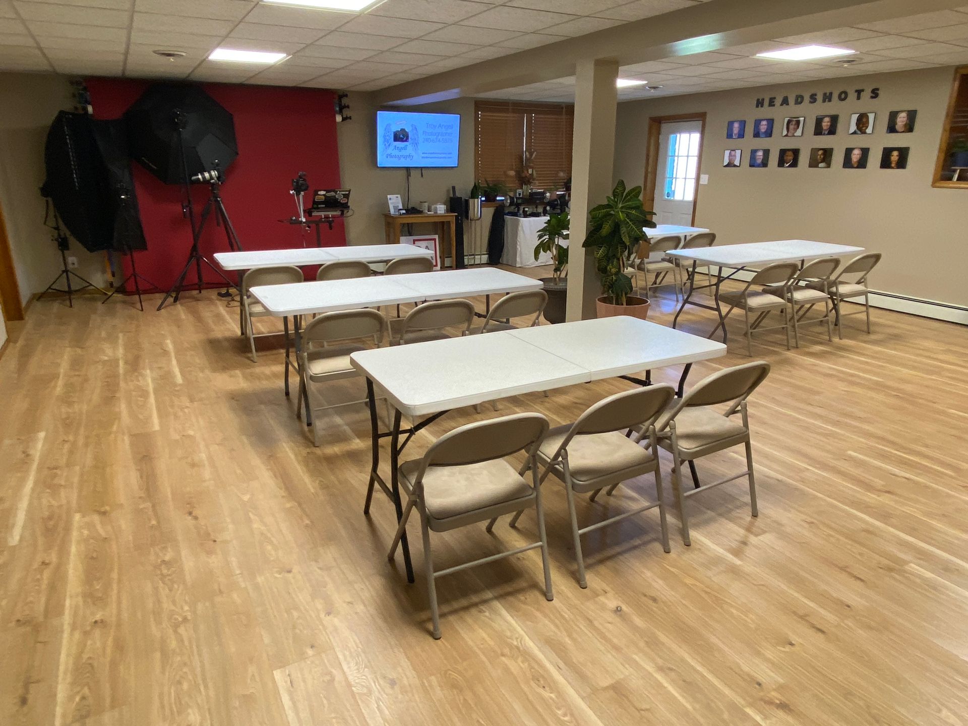 The photography classroom at Angell Photography setup with tables and chairs in preparation for a class.