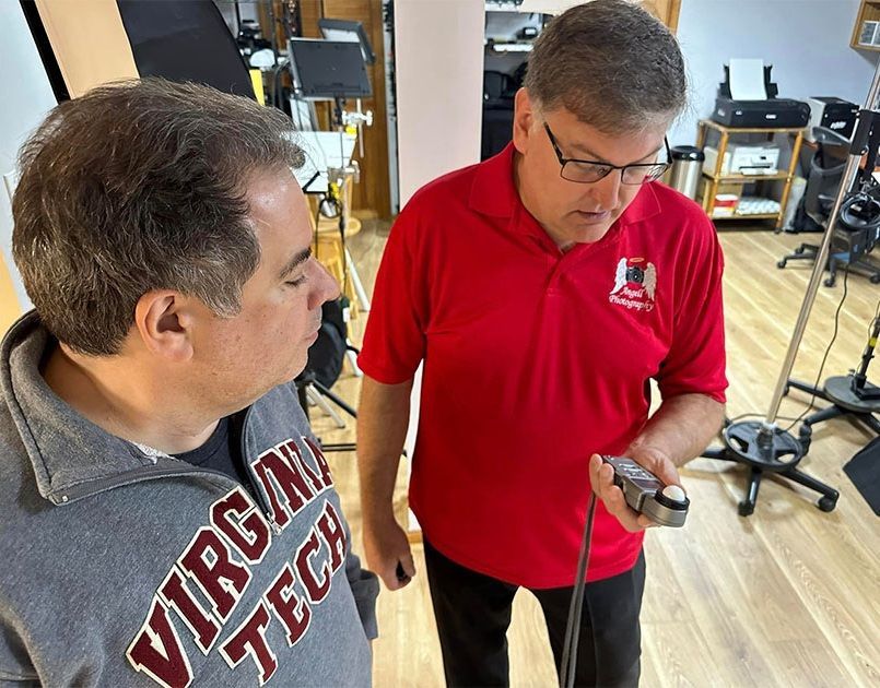 Photographer Troy Angell providing individual training to a photography student.