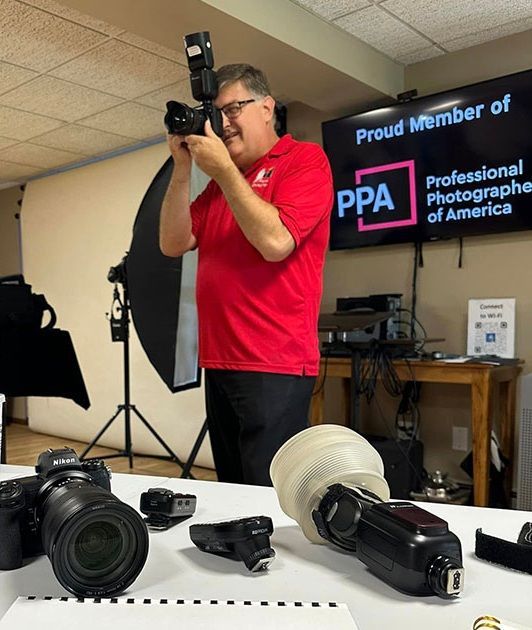 An instructor leading a workshop in a photography studio