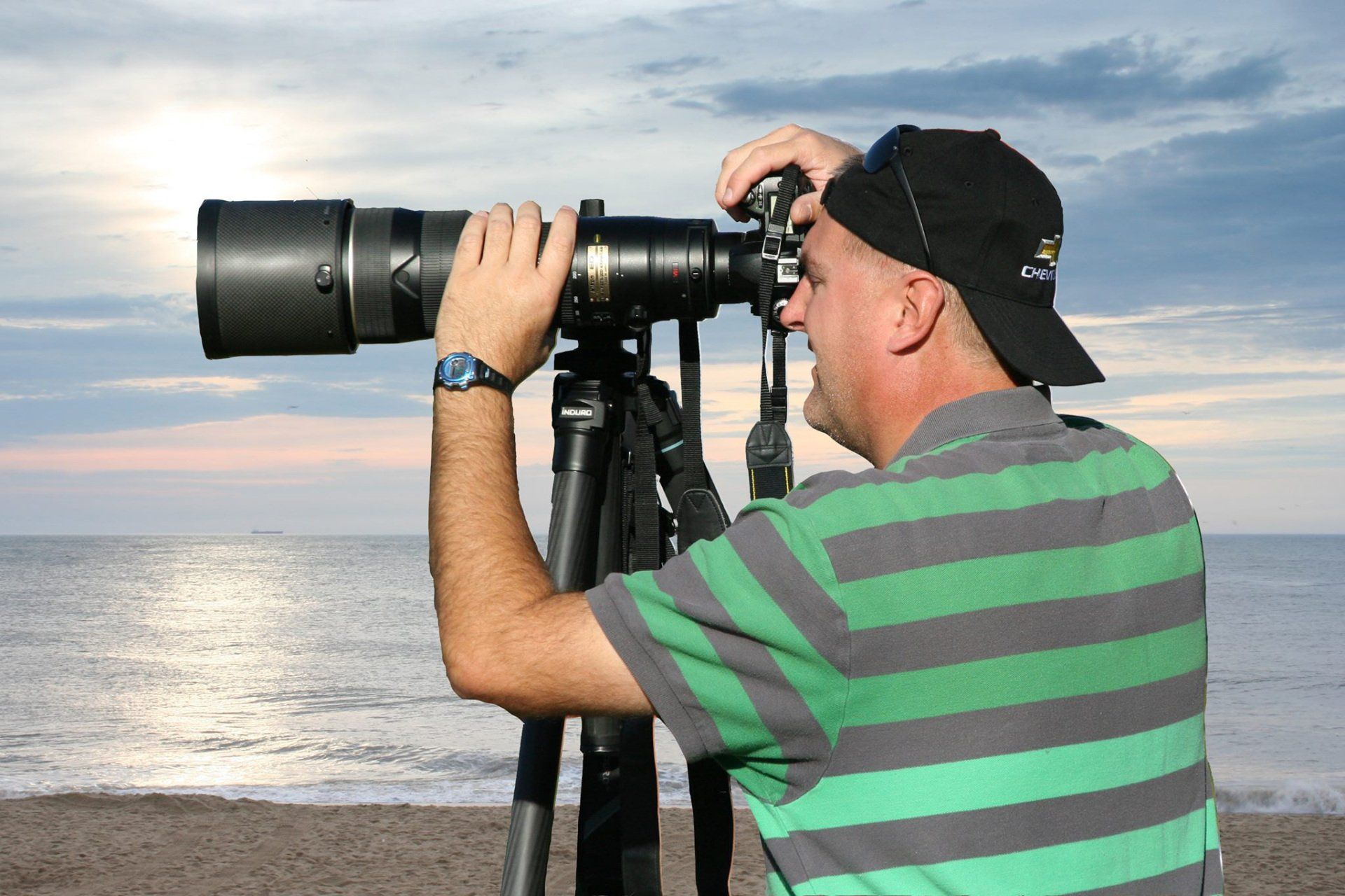 A man holding a camera and pointing it at the viewer