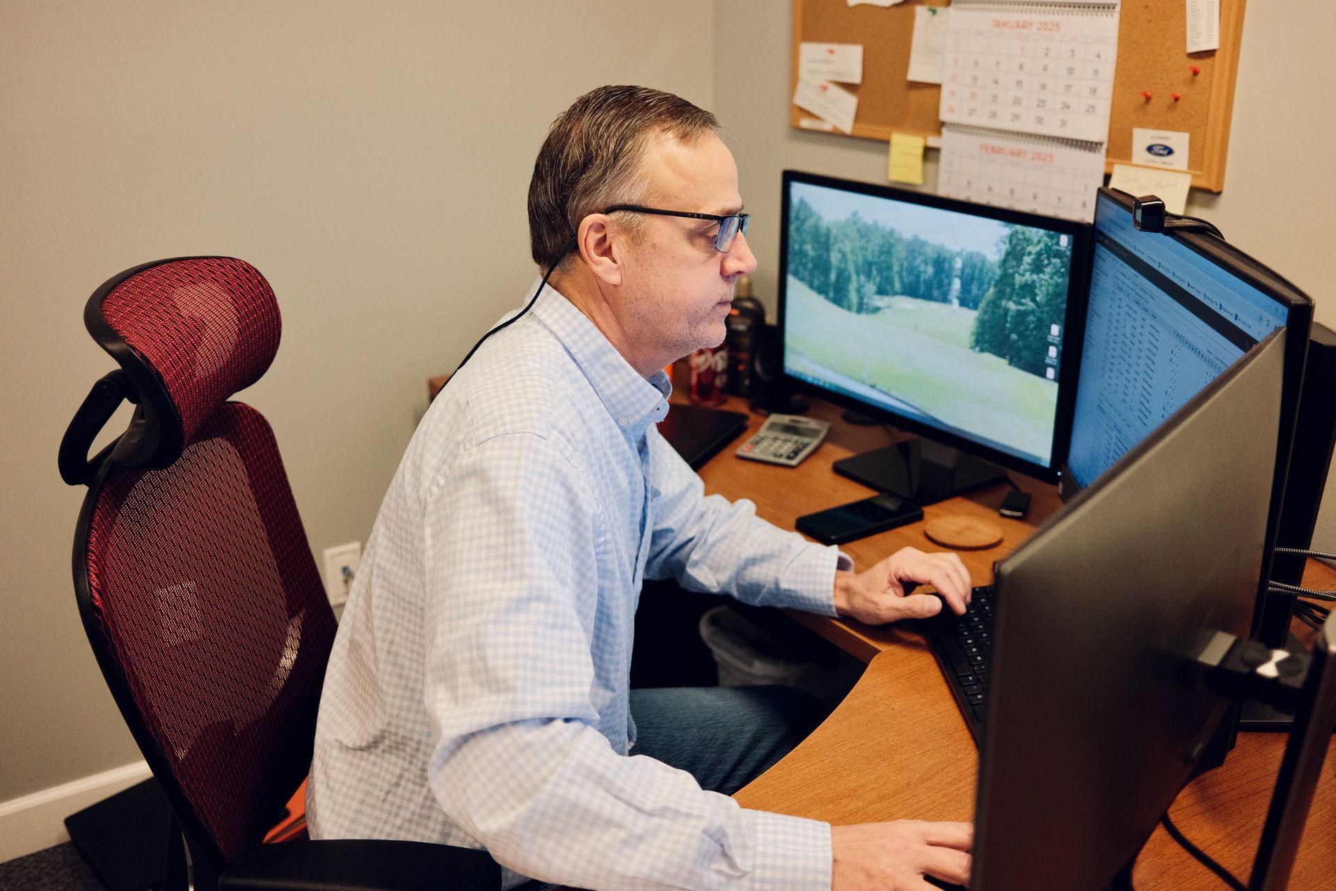 Man in blue shirt fixes computer