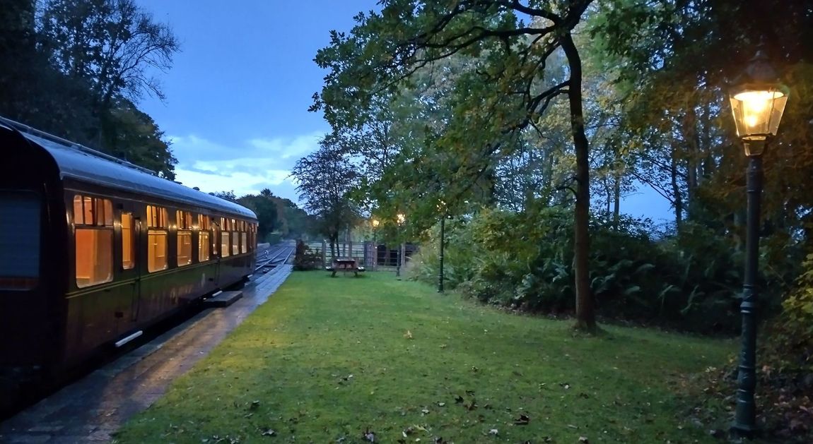 Our green platform 2 illuminated with the train carriage lights glowing at dusk