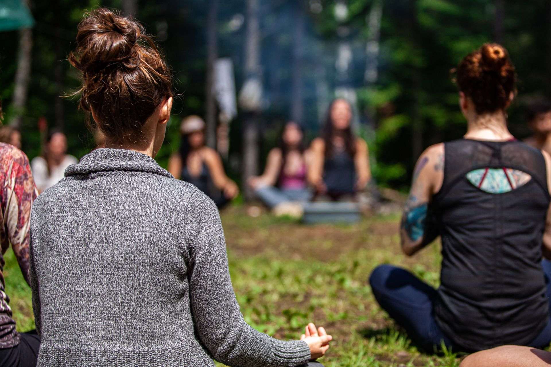 a group of people meditating in a field