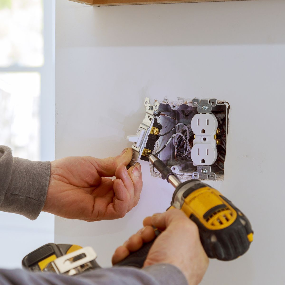 Leave electrical work to pros Electrician-style outlet and switch installation with wiring inside a wall box