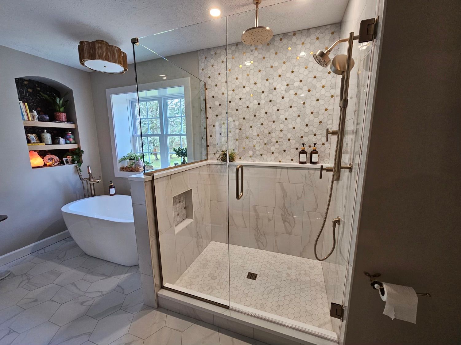 Luxury bathroom remodel with soaking tub and walk-in shower Luxury bathroom remodel with freestanding tub, tiled walk-in shower, and built-in shelving by Kitchen and Bath Remodeling Plus