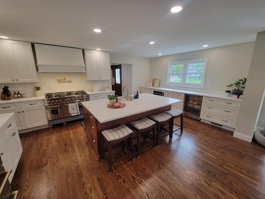 Explore a beautiful kitchen island that brings your home together. Modern white and wood kitchen island remodel with seating and built-in wine fridge
