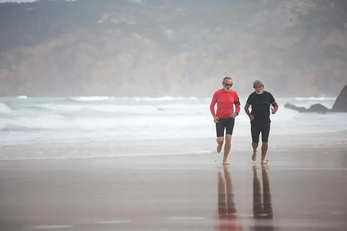 Older men running on the beach