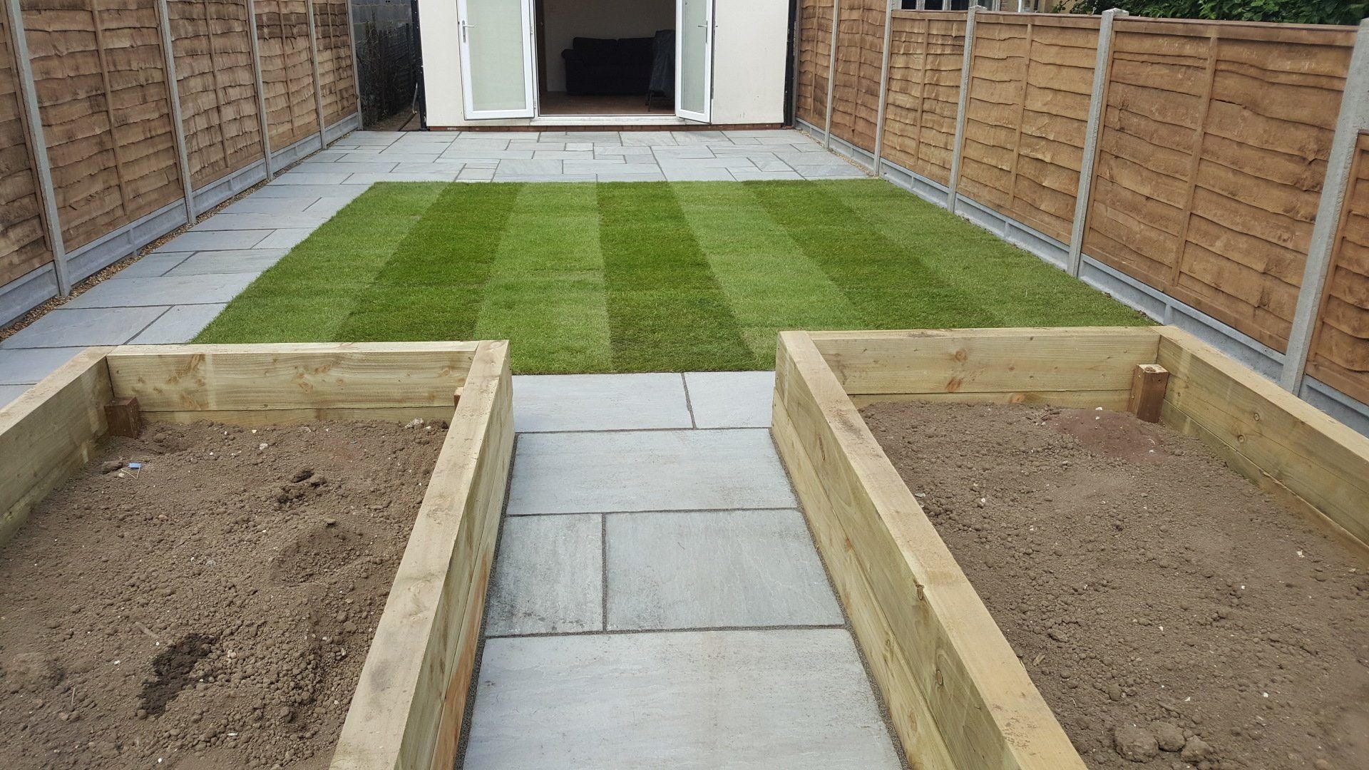 Wooden planters, lawn installation and paving