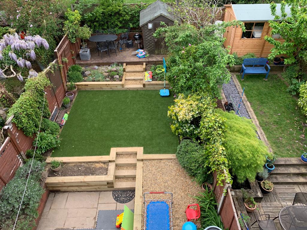 Wooden plantes, lawn installation and paving