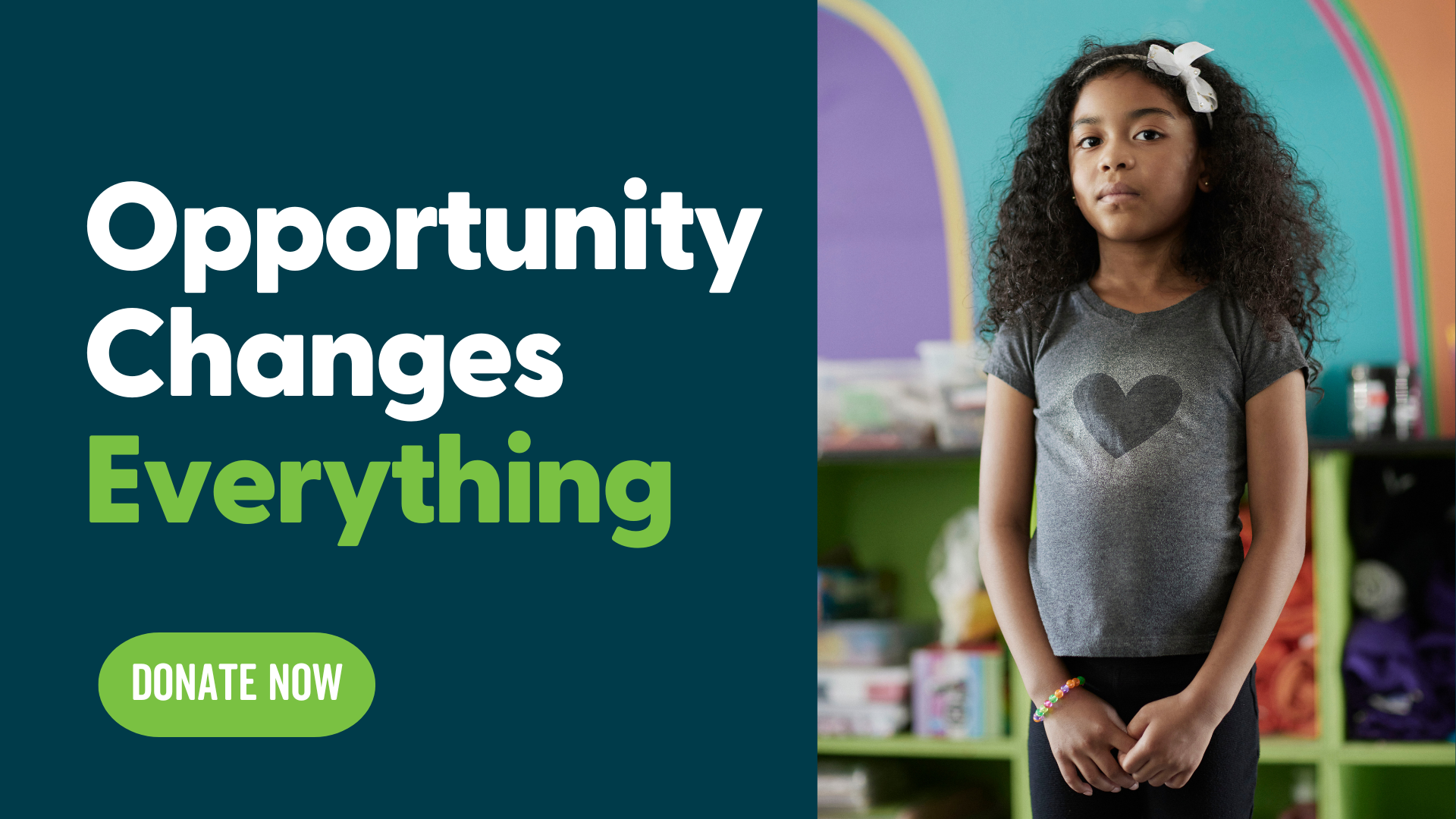 A young girl standing in a pleasant classroom.