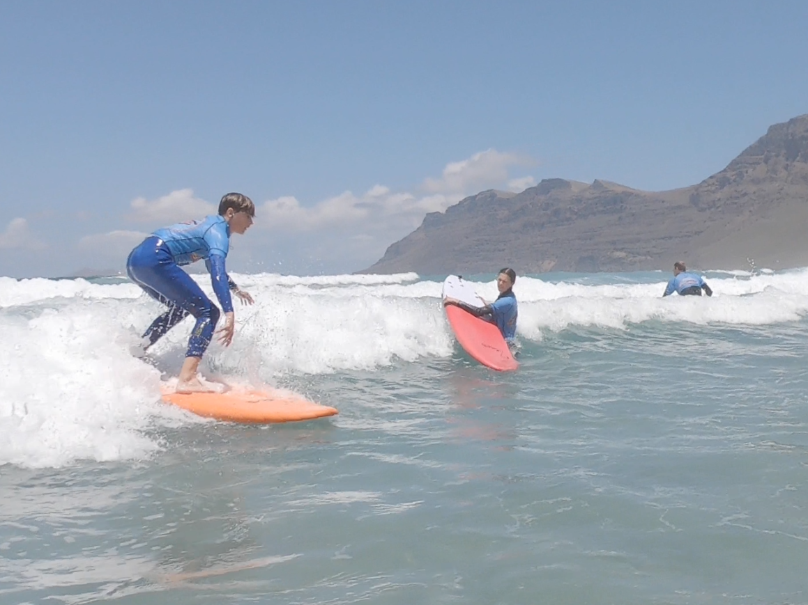 Beginner surfers sharing waves