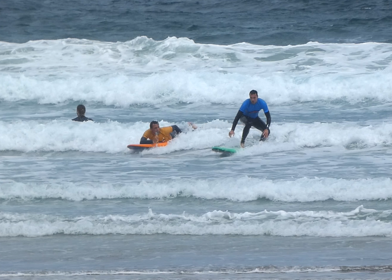 coach rides along with and films a surfer in a Private Lesson