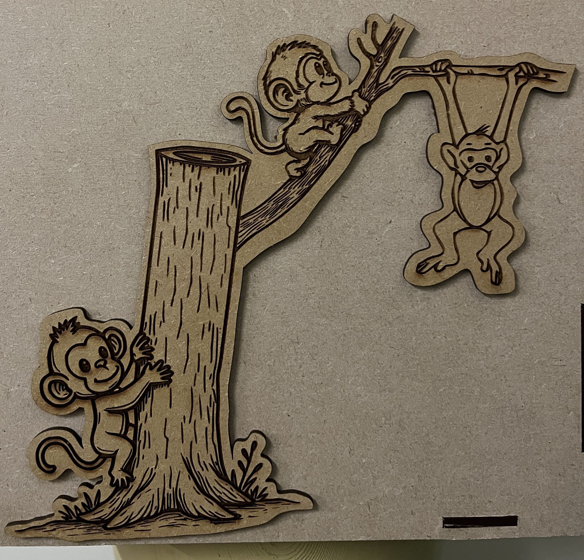 Monkeys playing in a tree engraved on MDF
