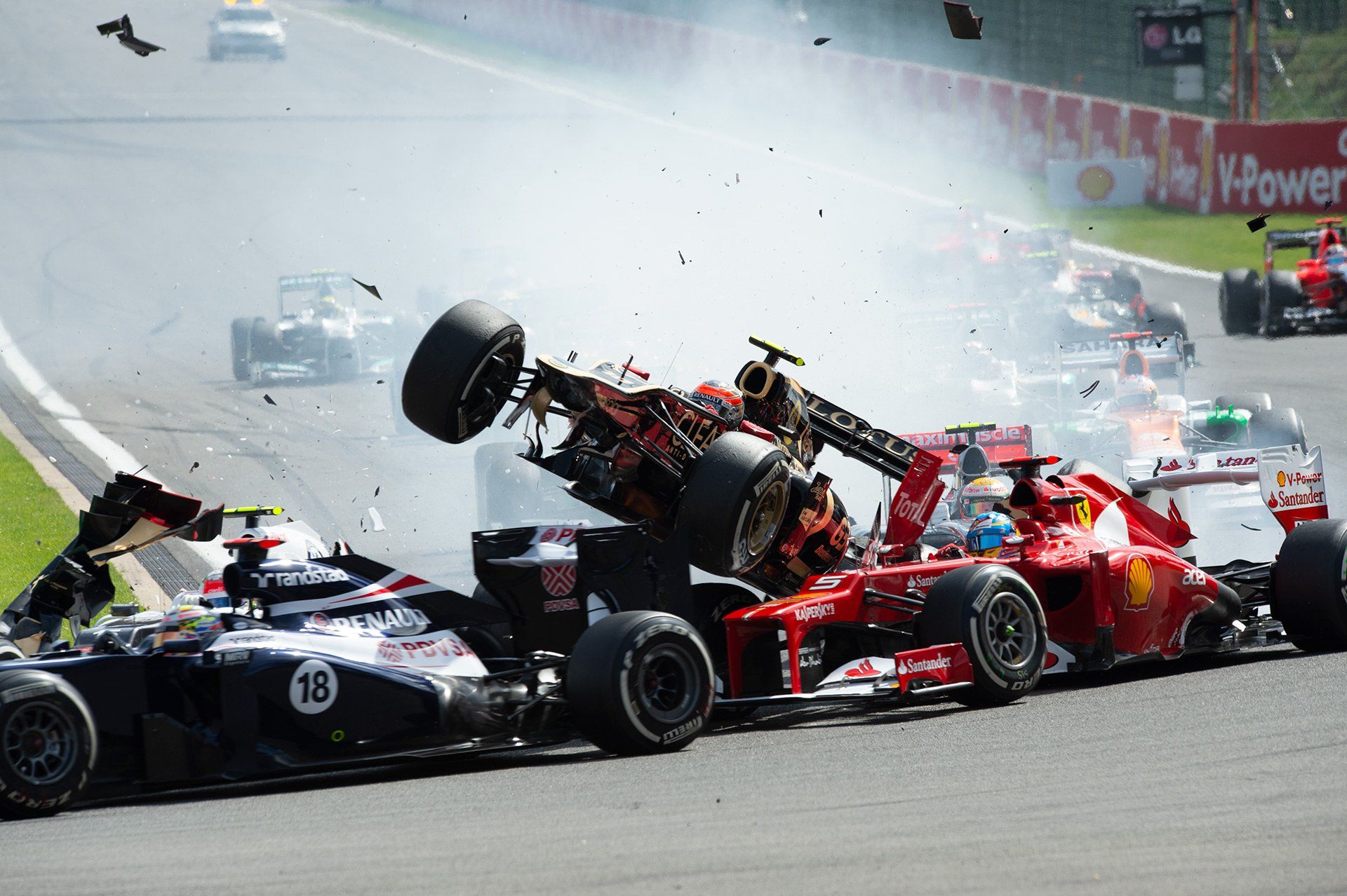 French Formula One driver Romain Grosjean crashes into Spanish driver Fernando Alonso of Ferrari during the start of the Formula One Belgian Grand Prix at the Circuit Spa Franchorchamps, Belgium, 2 September 2012. Photo: David Ebener/dpa