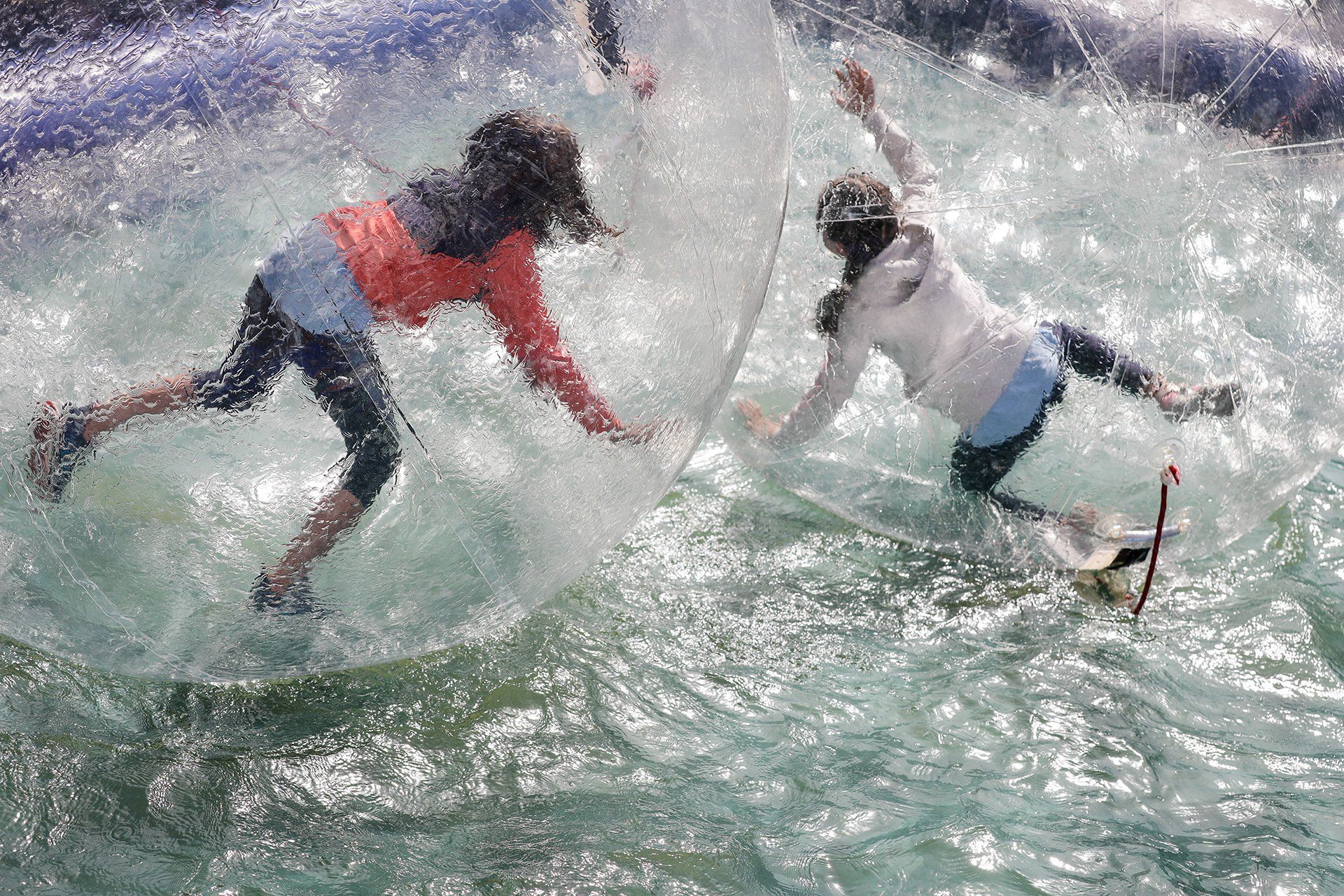 Aqua zorbing at the holiday pass opening party on 4 July 2019 in the courtyard of the Haus der Jugend in Osnabrück. Photo: David Ebener ***Keywords*** #holiday pass, holiday pass, holiday pass campaign, children, young people, opening