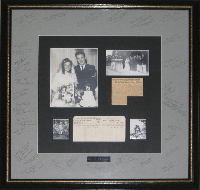 Shadow box for 50th wedding anniversary displaying photos, newspaper clipping, hotel receipt, and signature mat