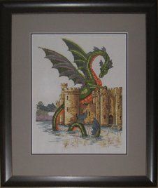 Cross-stitch of a dragon and castle framed in a charcoal frame with two-tone grey mats