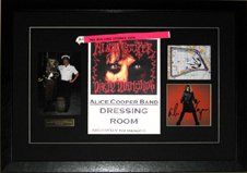 Signed CD cover, dressing room door sign, photo, wrist band framed in a black faux leather shadow box with black mats