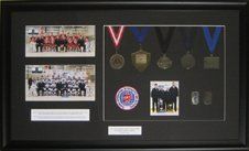 Bedford Blues AAA Hockey Team memorabilia shadow box Team and coach photos, medals and pins from tournaments framed in a black shadow box with black mats