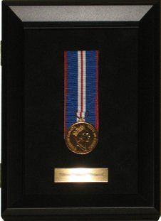 Queen's Golden Jubilee medal and nameplate framed in a black shadow box that opens