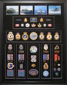 Photos, badges, patches, cap badges from RCN service framed in a black shadow box with black suede mats