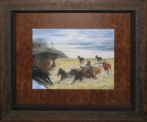A painting of a cowboy and horses framed with a double rustic frame and brown leather and suede mats