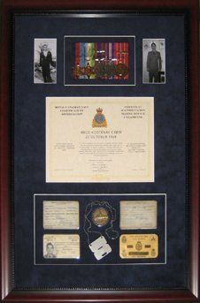 Photos, medals, certificate of appreciation to HMCS Kootenay crew, dog tags, and IDs framed in a mahogany shadow box with blue suede mats