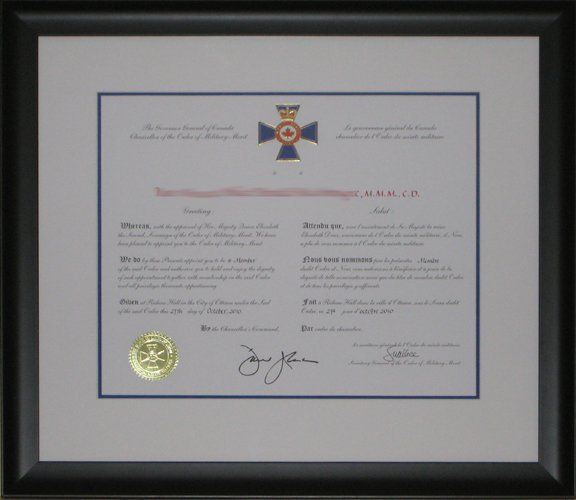 Order of Military Merit certificate framed in a black frame with white and blue mats
