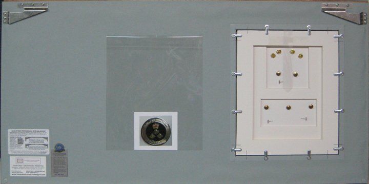 Back view of the shadow box where medals can be accessed Back view of the shadow box showing a trap door where the medals and ribbon bar can be accessed