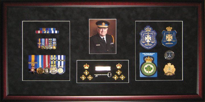 Shadow box for police memorabilia Portrait, medals and ribbon bar, rank insignia, badges framed in a mahogany shadow box with black suede mats