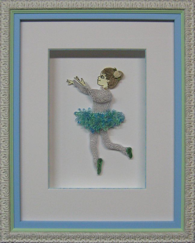 A ballerina paper tole artwork framed in a shadow box made with a white ornate frame, a blue frame, a green fillet, and a white mat with a hand-painted bevel.
