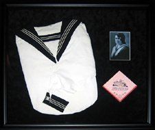 Photo of grandmother, school shirt and handkerchief framed in a black shadow with black suede mats