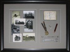 A father's work tools, time sheet book, and photos of him at work framed in a charcoal tone shadow box with grey mats