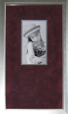 Young Girl Holding Flowers B&W Photo A black & white photo of a young girl holding flowers framed in a silver metal frame with burgundy suede mat