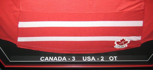 Close-up of the score Canada - 3, USA - 2 displayed along the bottom spacer of the shadow box