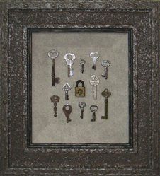 Antique lock and keys shadow box Antique lock and 12 keys framed in an aged steel looking frame with grey mottled fabric tray mat