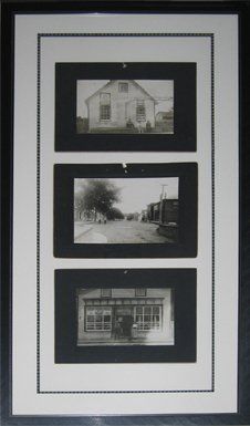A set of 3 black & white old photos of the street in Lyndhurst framed in a black metal frame with white mats