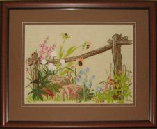 Crewel of a rustic fence post with flowers framed in a brown frame with brown mats