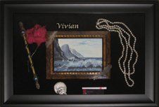 Memorial shadow box Necklace, lipstick, painting, rose, wand, feathers, teacup & saucer framed in a black shadow box and black suede mats