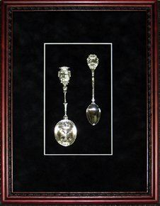 Silver spoons shadow box Two silver spoons framed in a mahogany shadow box with black suede mats