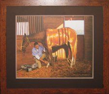 Print of a vet and horse in a stable framed in a rustic frame with dark brown and rust mats