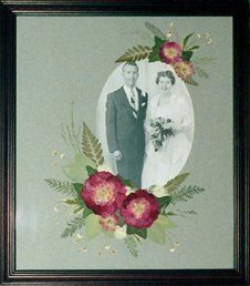 Wedding Photo with Pressed Flowers Frame displaying a wedding photo with hand-pressed flower decoration on the mat