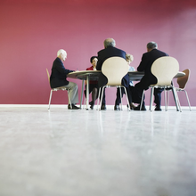 Photo of people sitting having a meeting