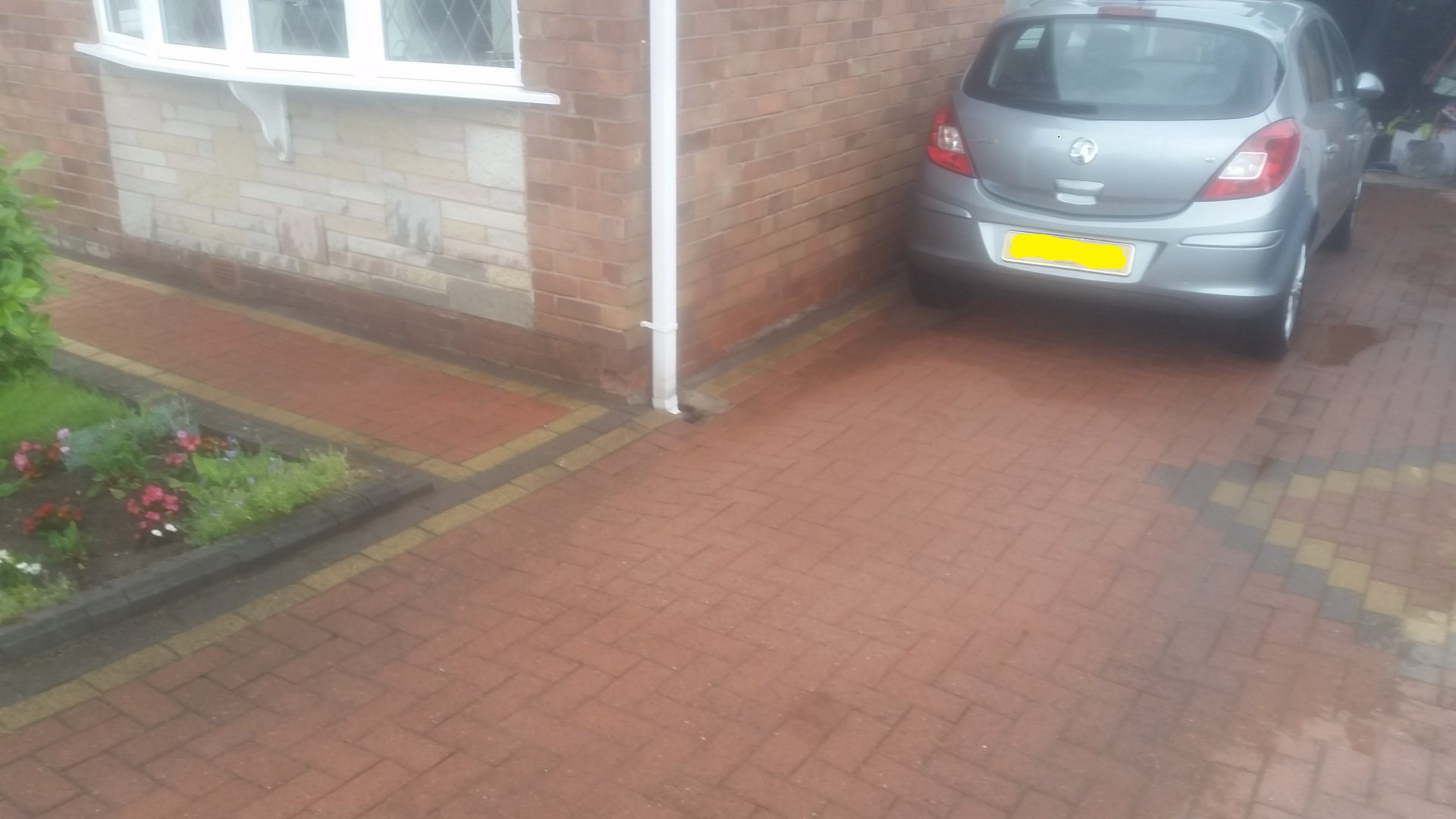 Block paved driveway with oil stain after cleaning